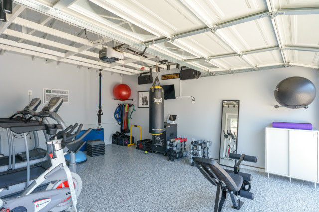 Garage converted into modern home gym in Encino by T&N Remodeling Inc